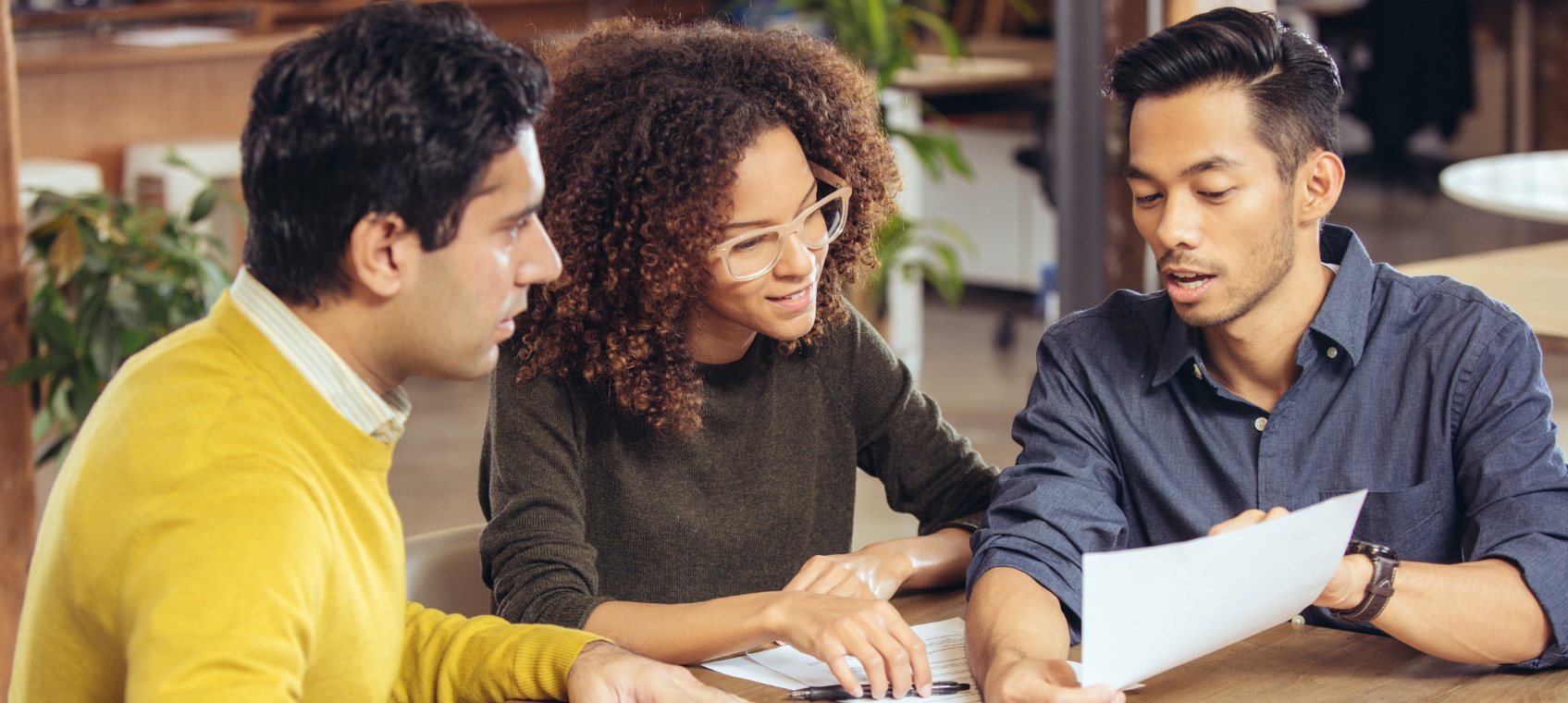 A few people looking at a paper.