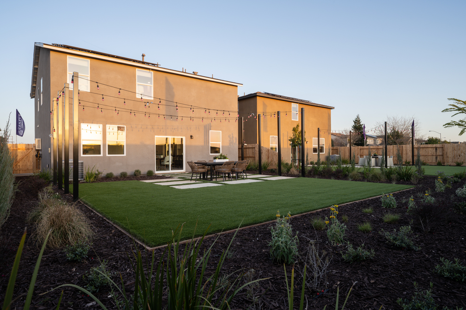 A building with a lawn and a table in front of it.