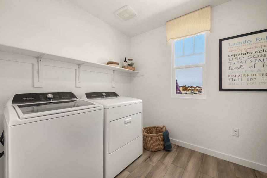 A kitchen with a washer and dryer.
