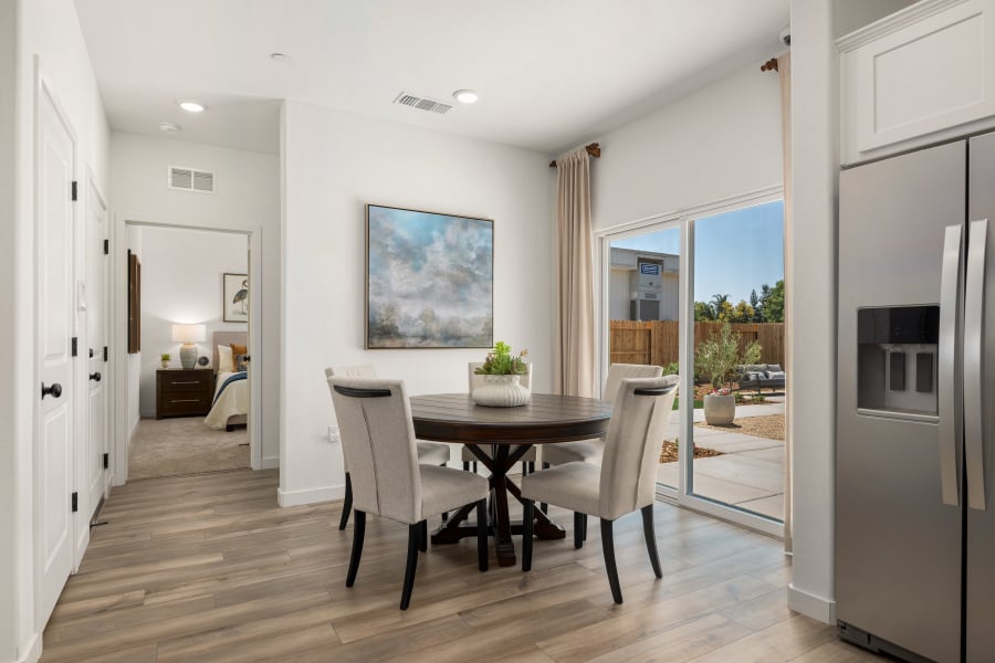 A dining room with a large glass door.