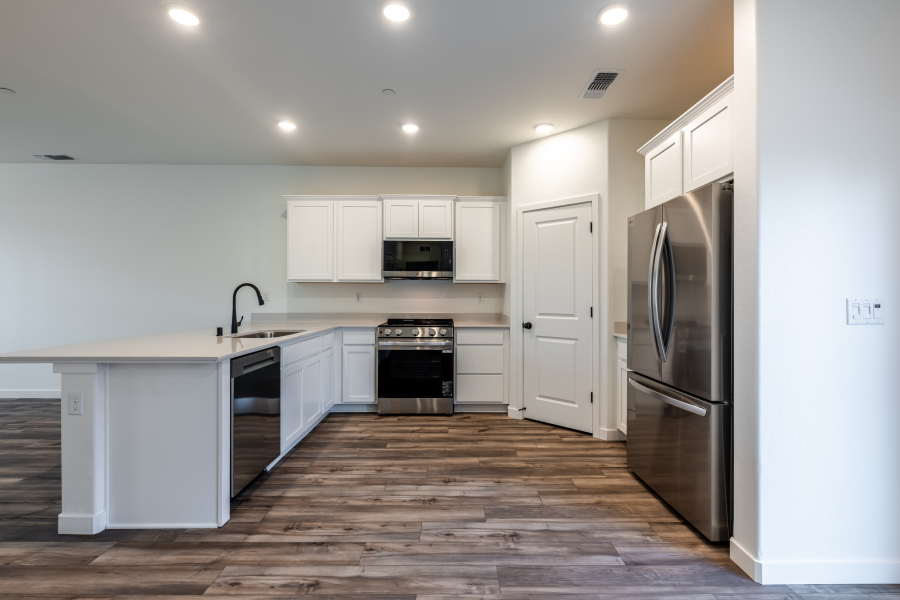 A kitchen with white cabinets.