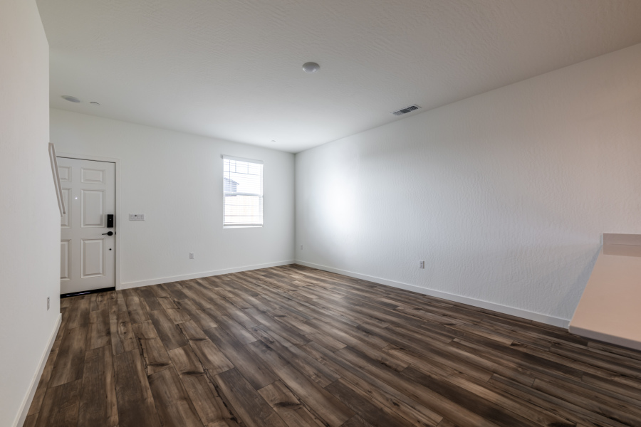A room with a wood floor and white walls.