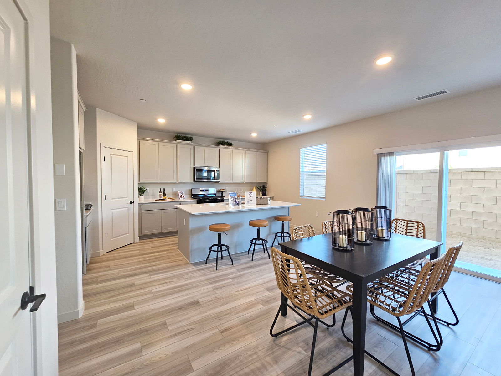 A kitchen with a dining table and chairs.