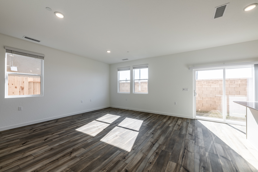 A room with windows and a wood floor.