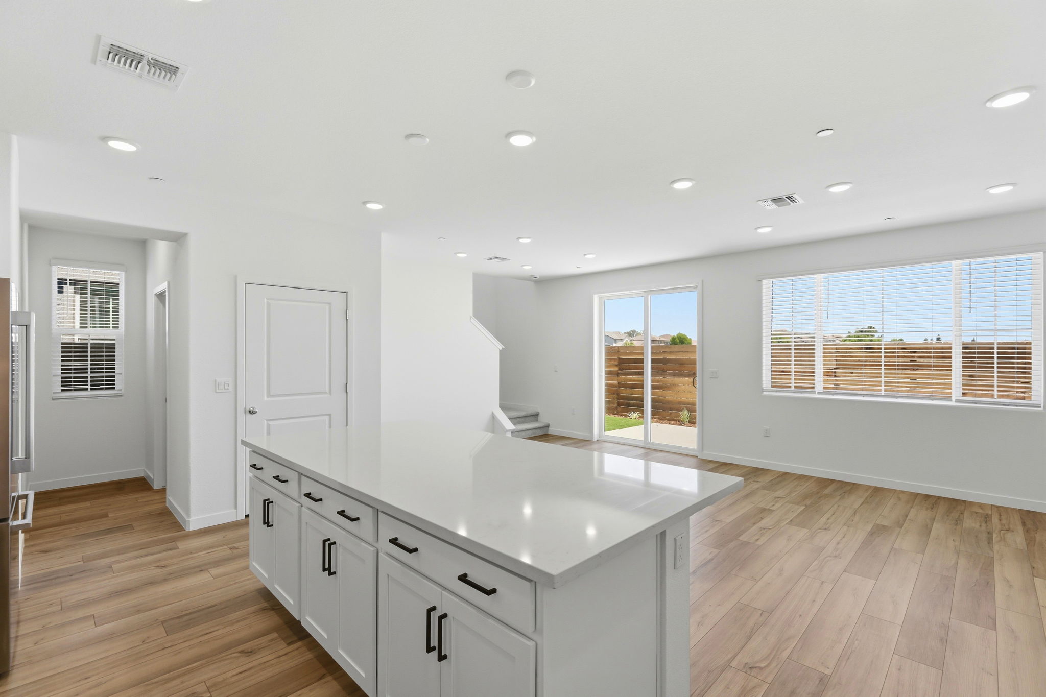 A kitchen with white cabinets.