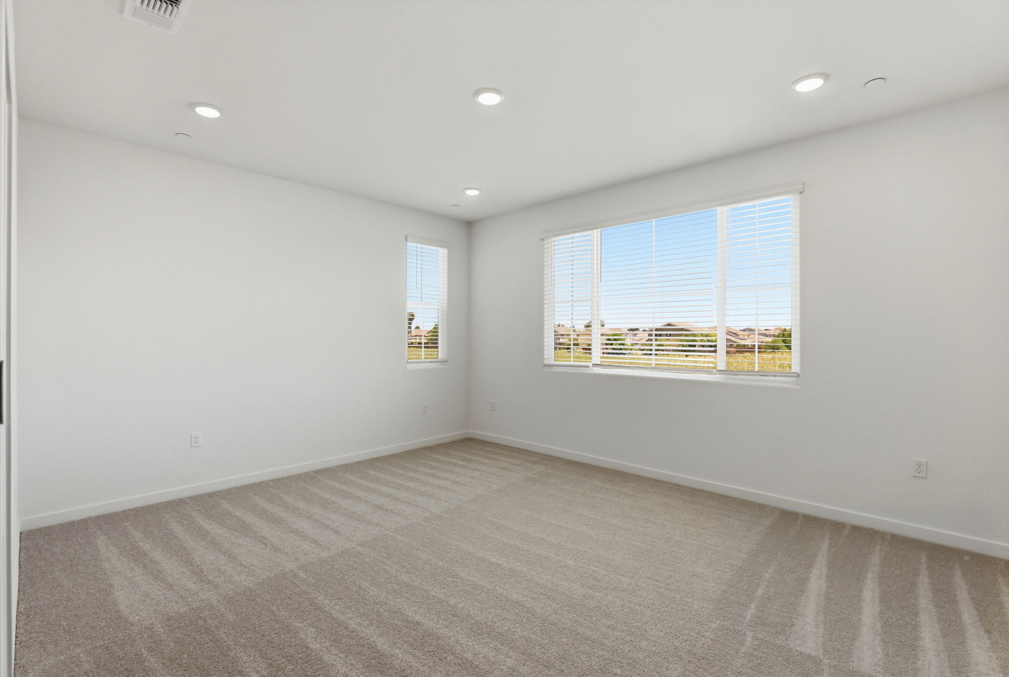 A room with a window and a carpet.