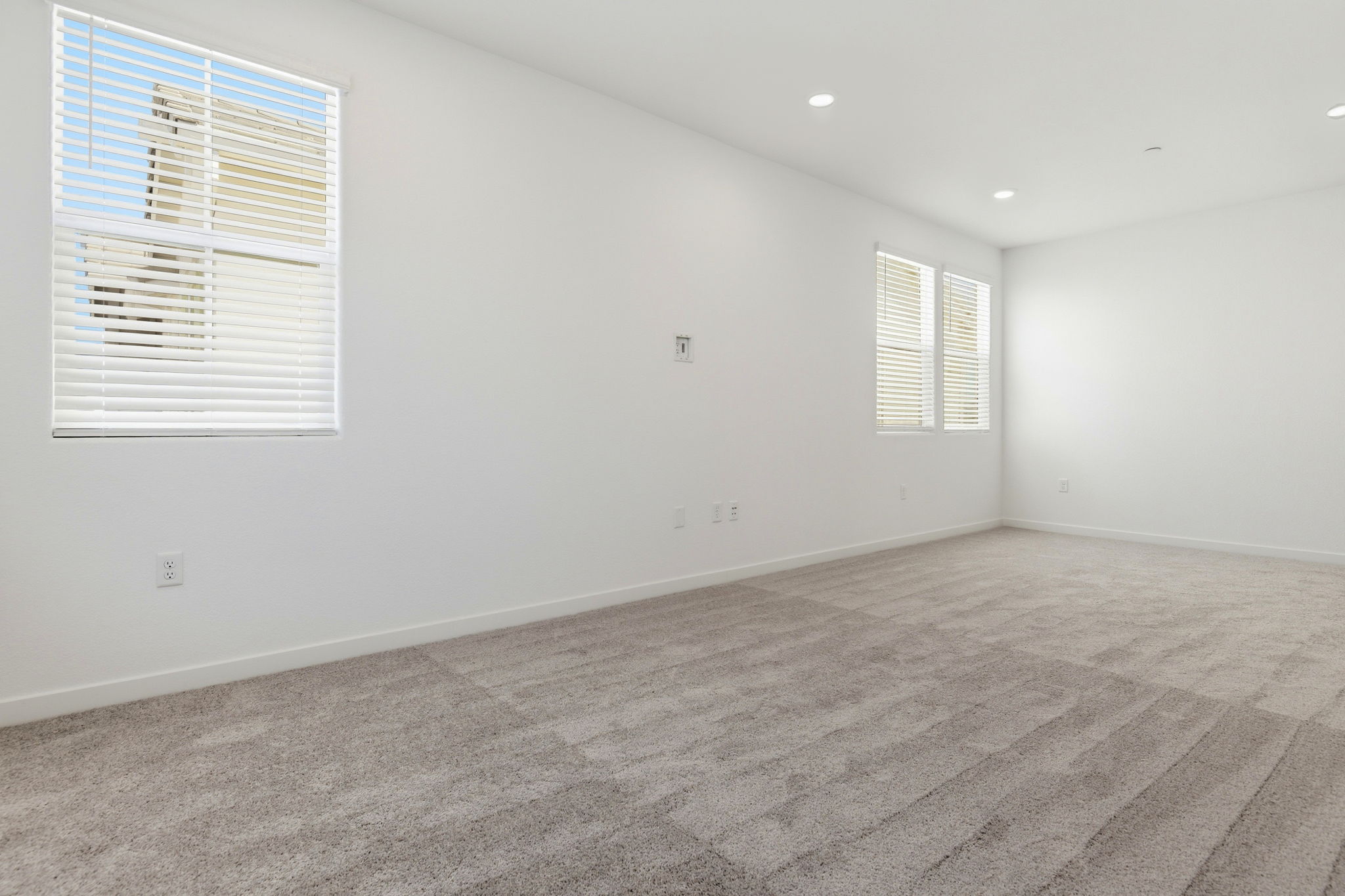 A room with a wood floor and white walls.