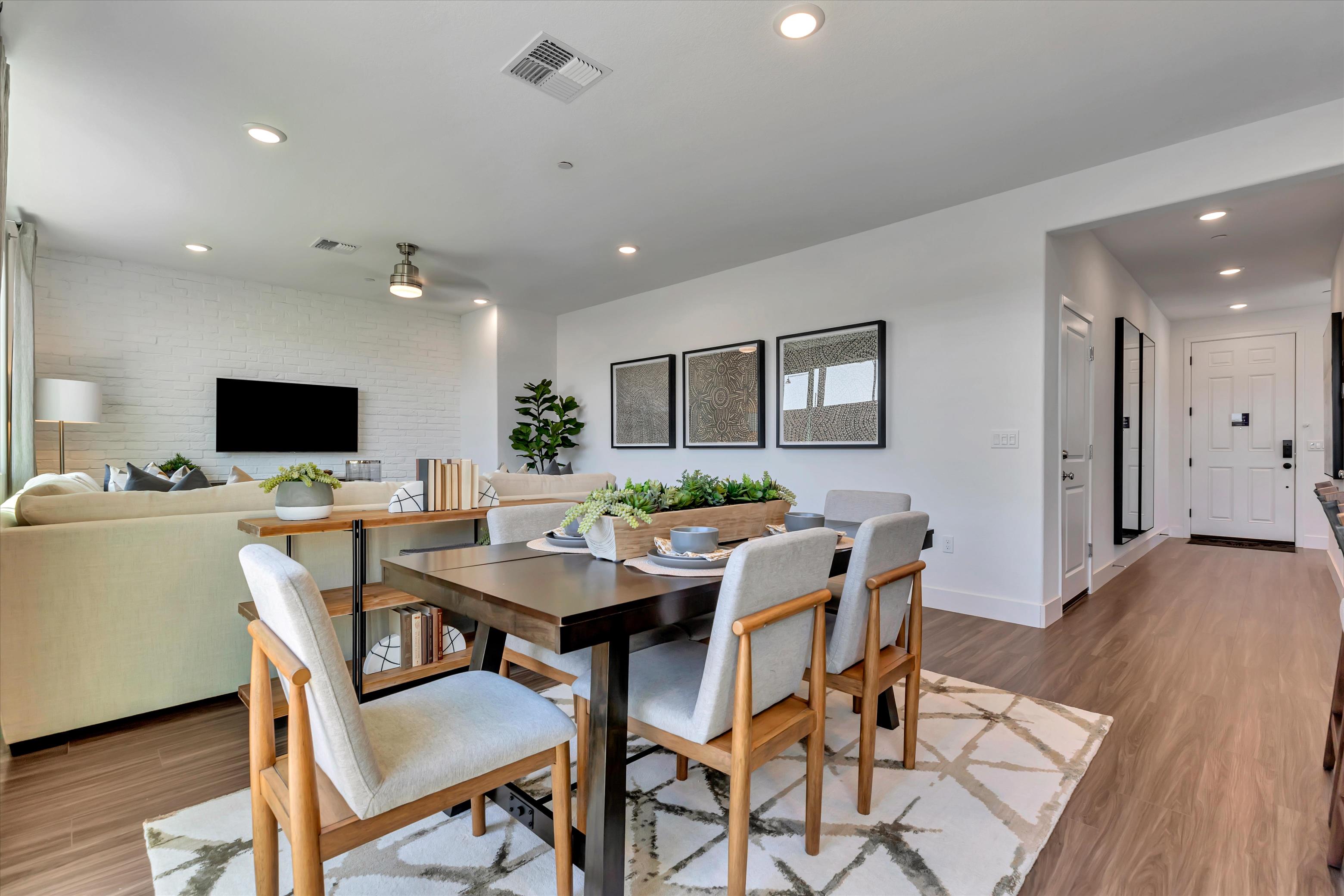 A dining room with a couch and a table.