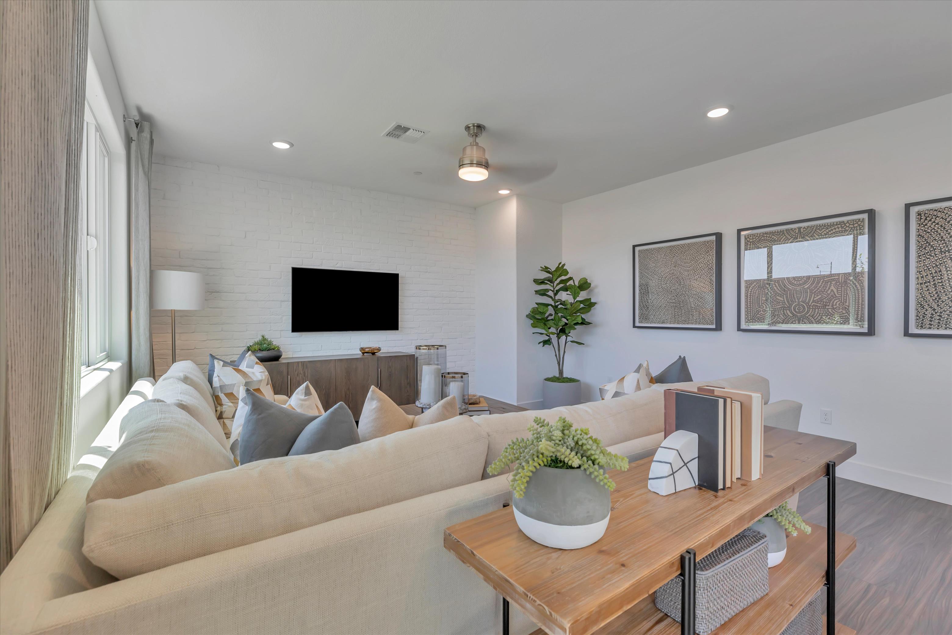 A living room with a large television.