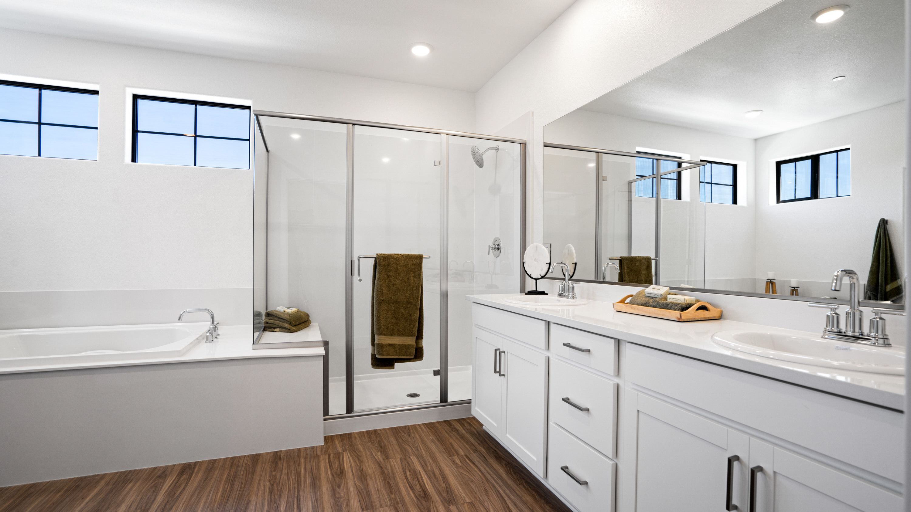 A bathroom with a tub sink and a shower.
