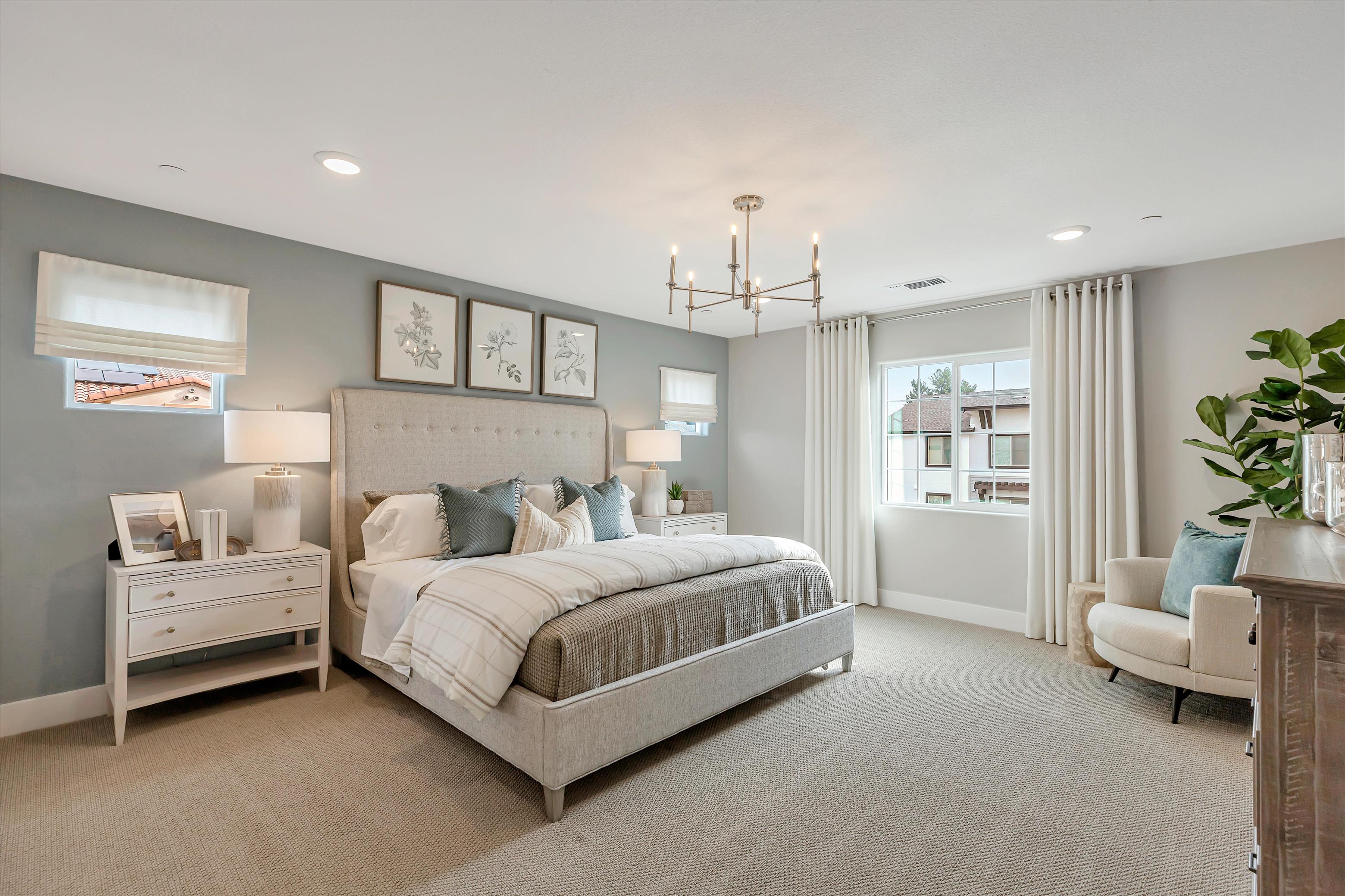 A bedroom with a bed and a chair.