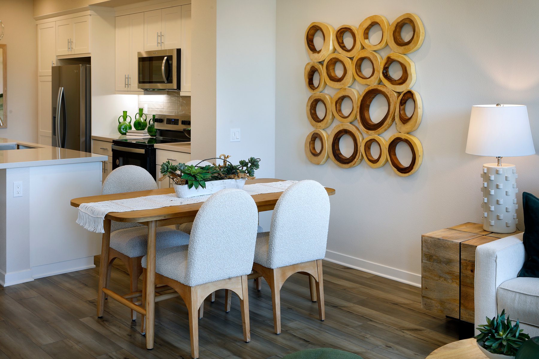 A dining room with a table and chairs.