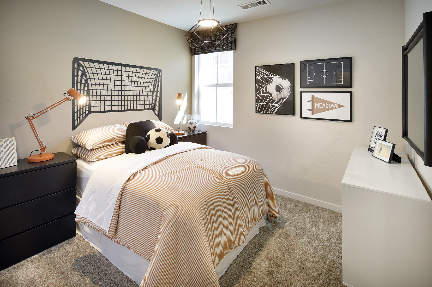 A bedroom with a bed and a lamp.