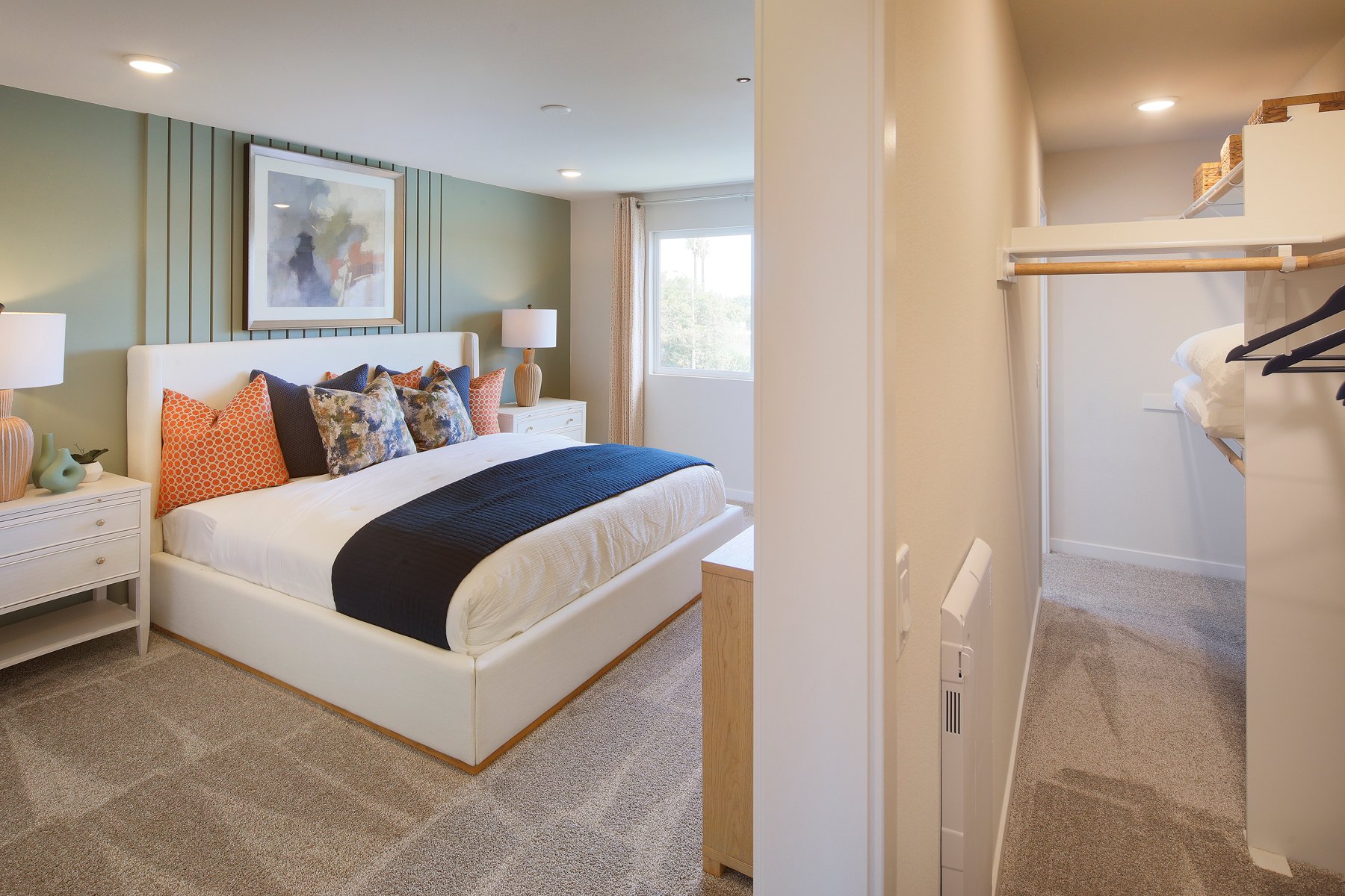 A bedroom with a bed and lamps.