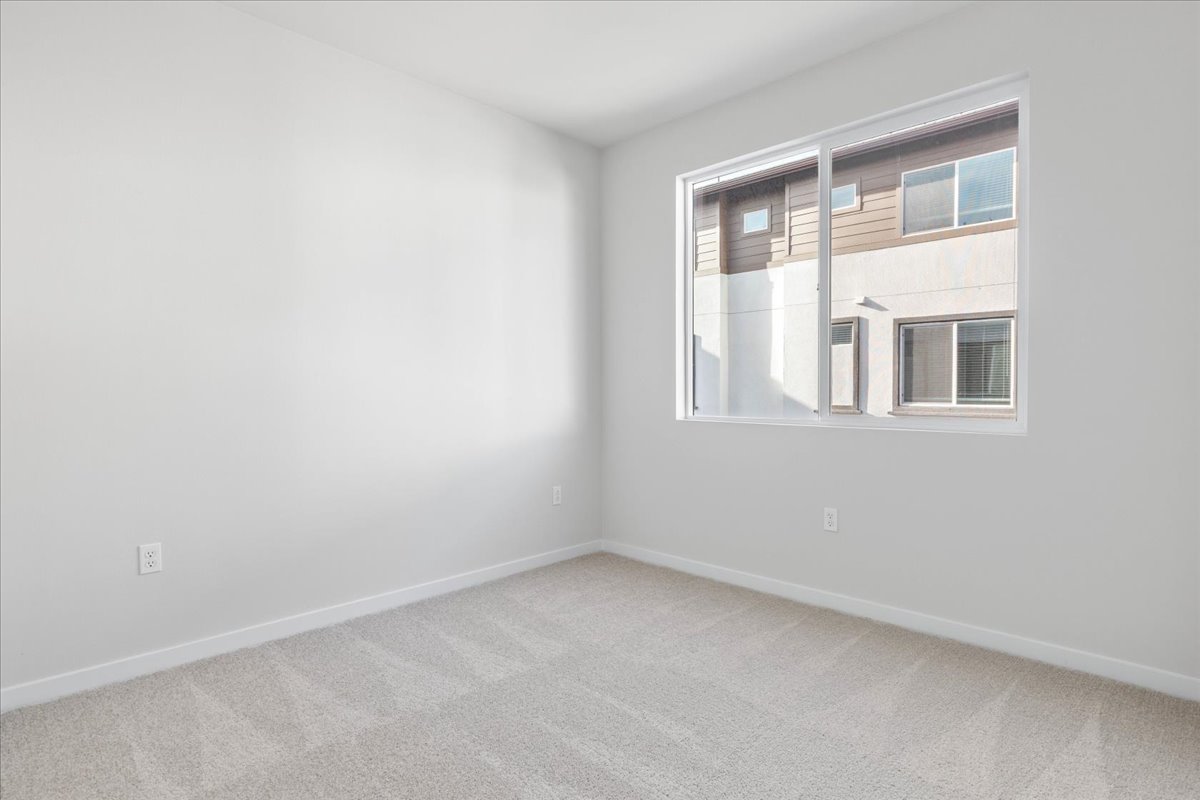 A room with a window and a carpet.