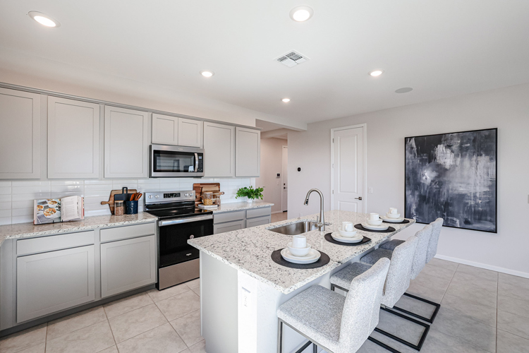 A kitchen with white cabinets.