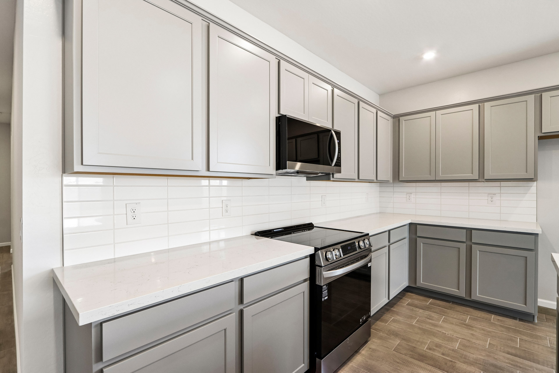 A kitchen with white cabinets.