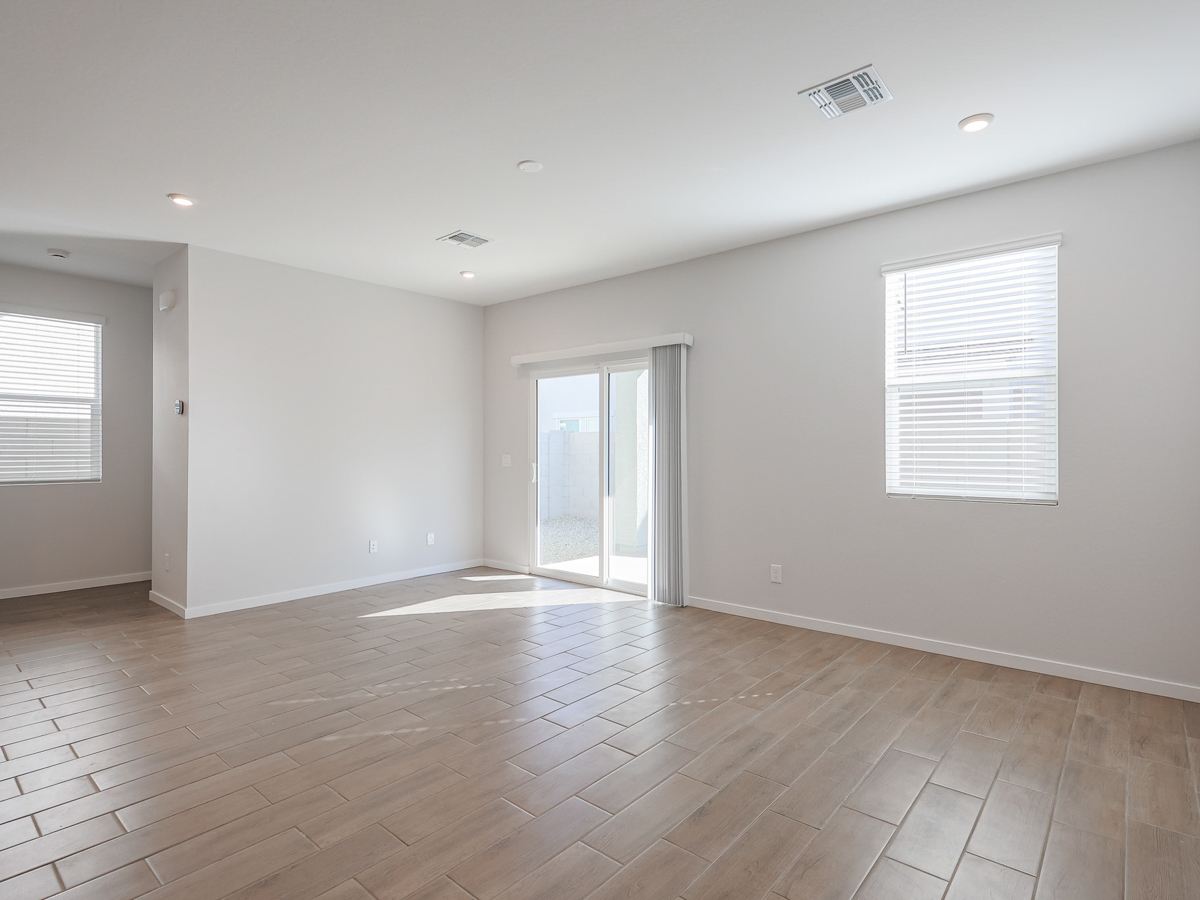 A room with white walls and a wood floor.