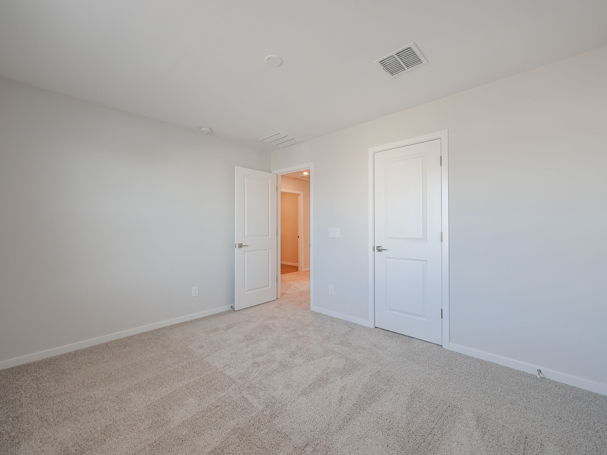 A hallway with white doors.