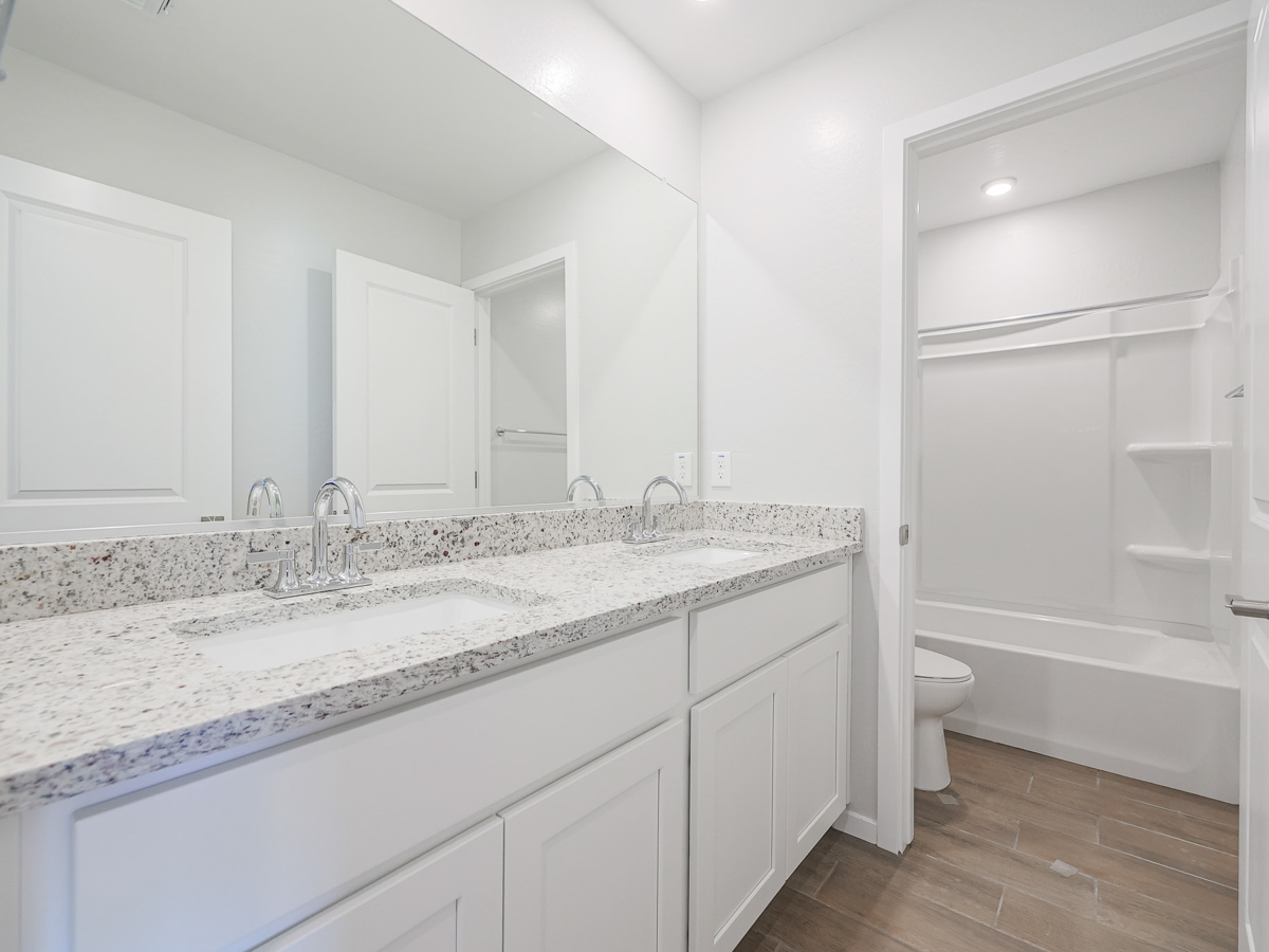 A bathroom with a tub sink and toilet.