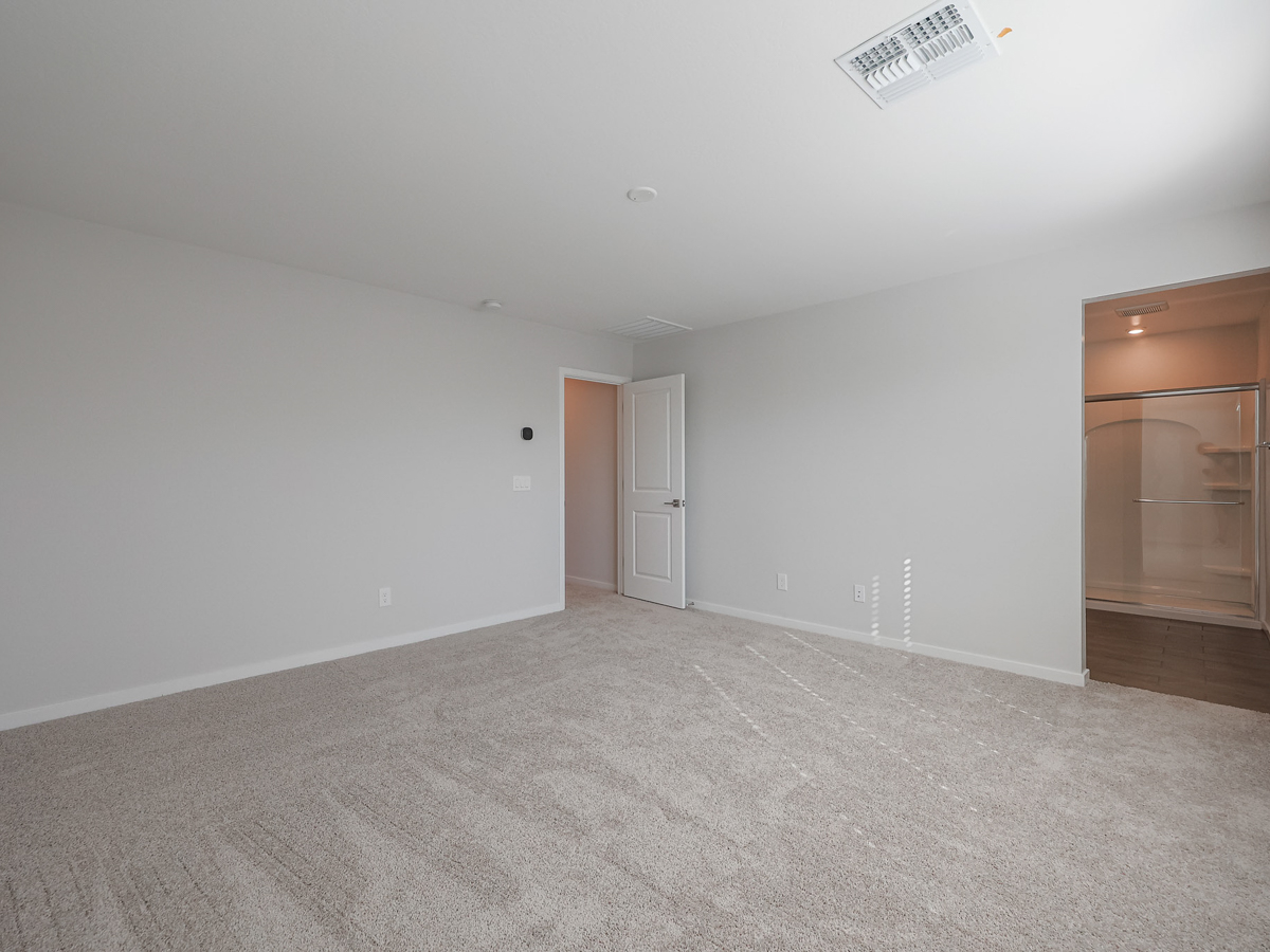 A room with a carpet and a door.