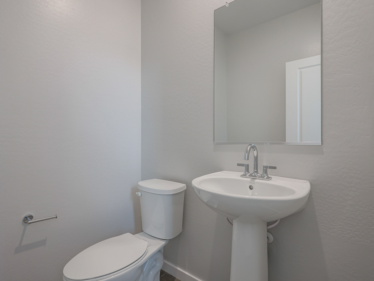A bathroom with a sink and toilet.
