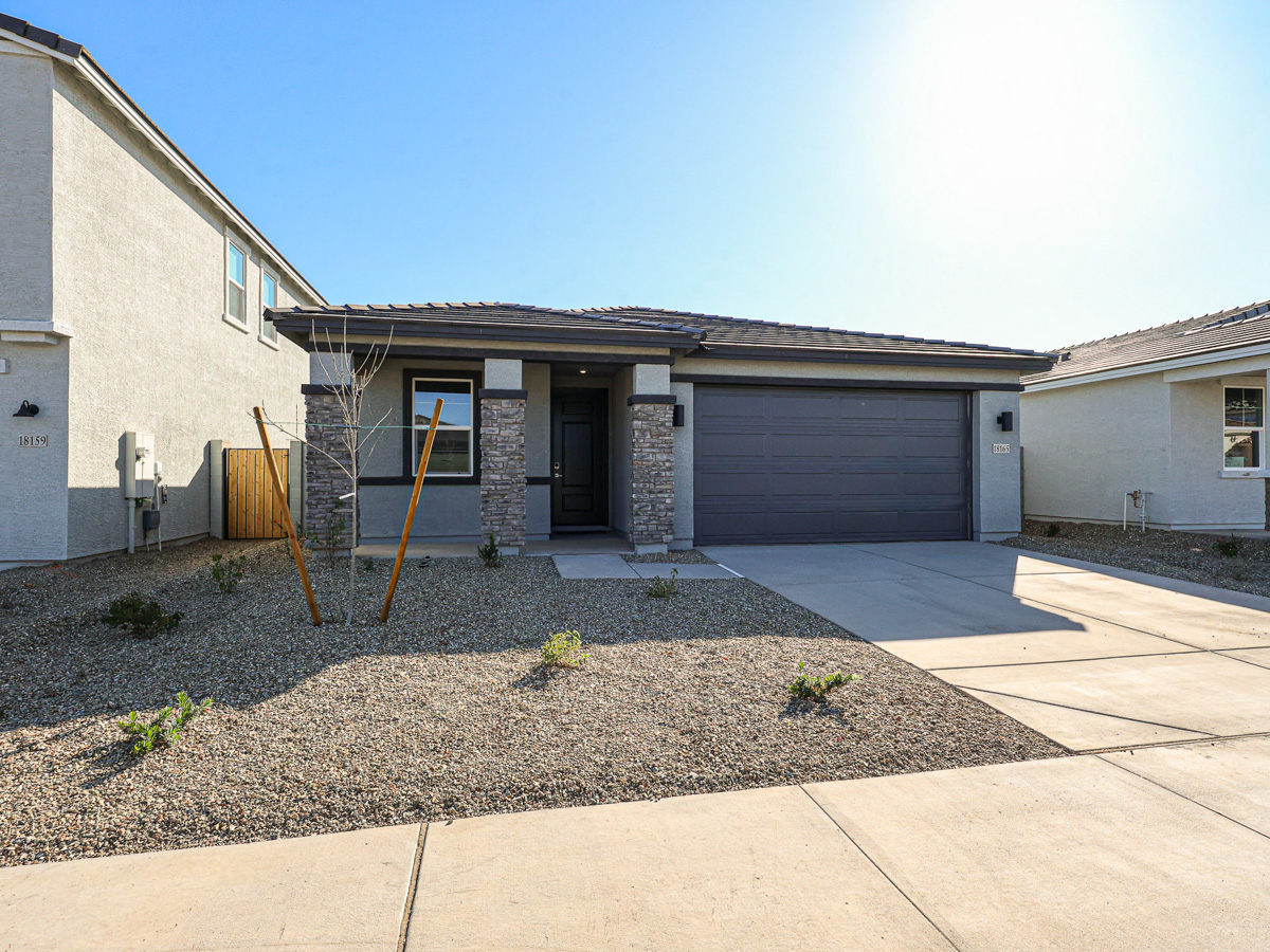 A house with a garage and a ladder in the front.