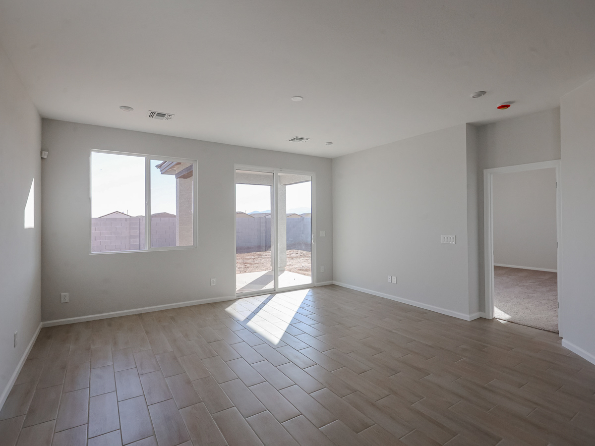 A room with a wood floor and windows.