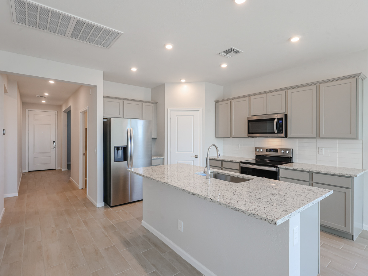 A kitchen with white cabinets.