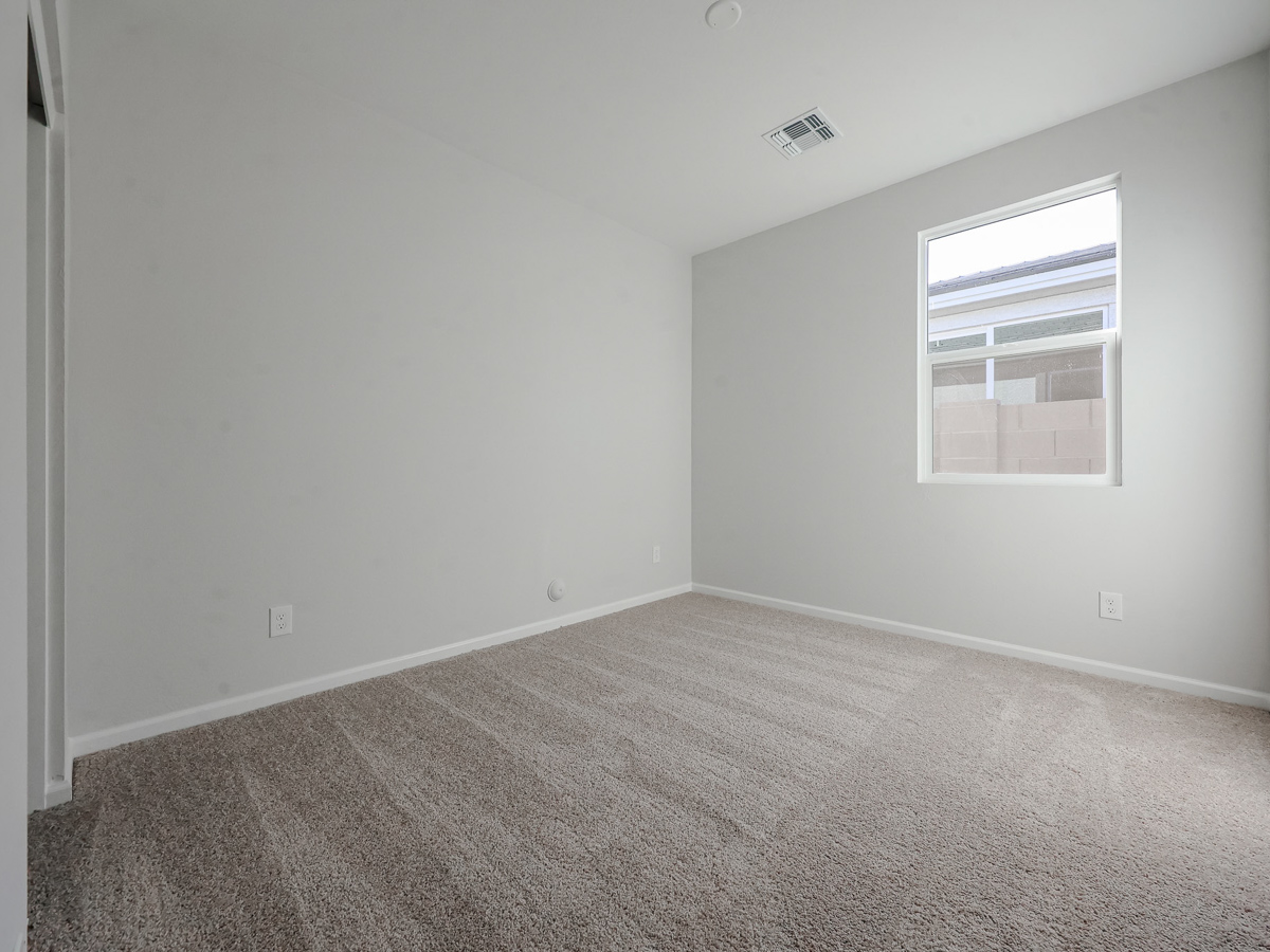 A room with a window and carpet.