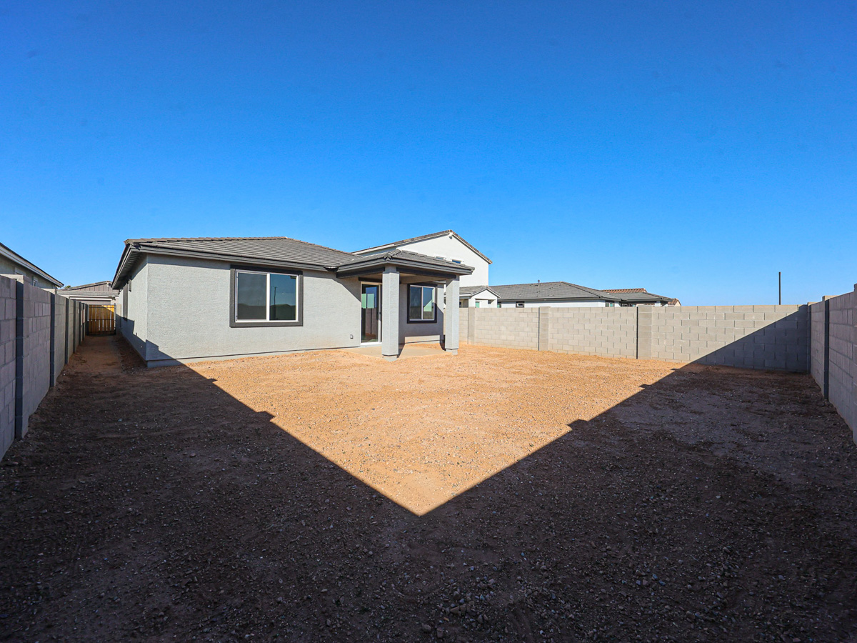 A house with a dirt yard.