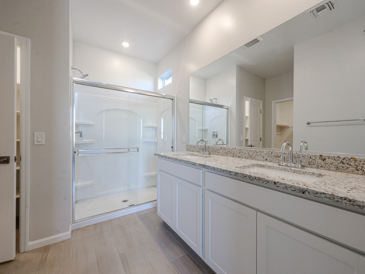 A bathroom with a large mirror.