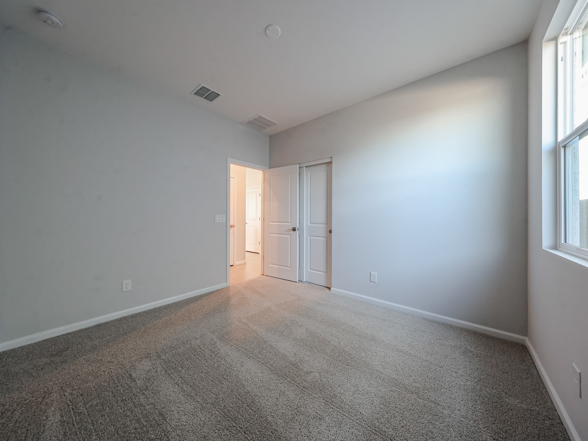 A room with white walls and a carpeted floor.