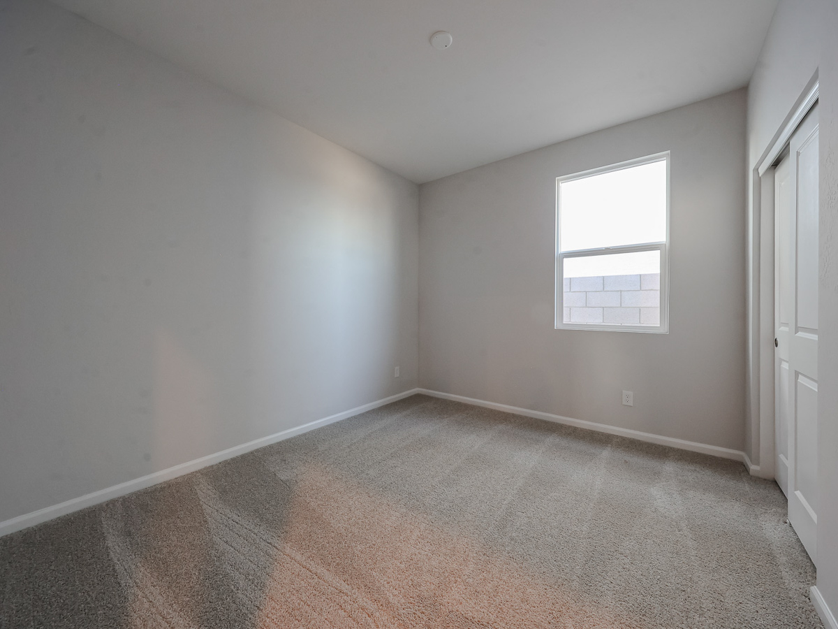 A room with a window and a carpet.