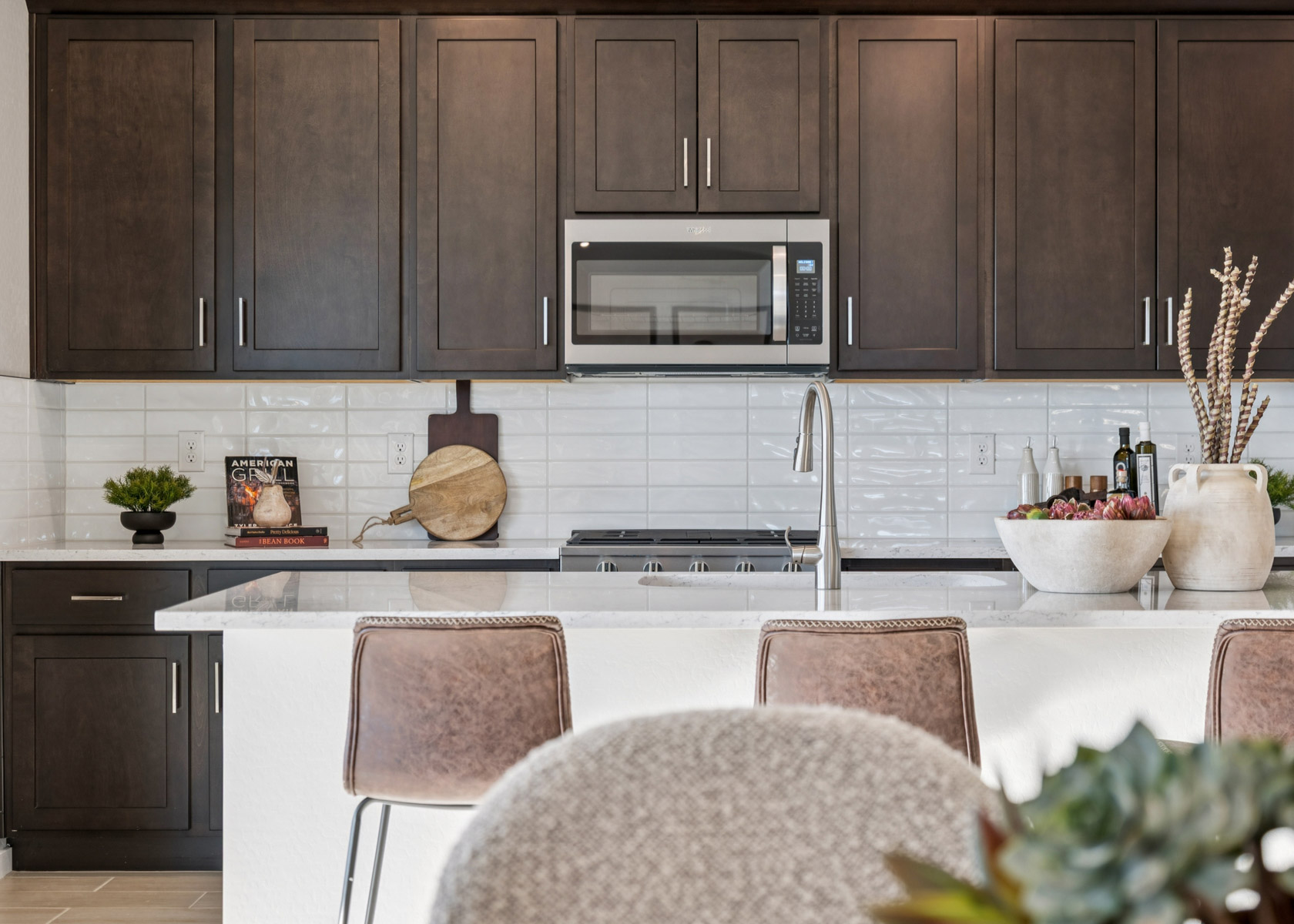 A kitchen with a table and chairs.