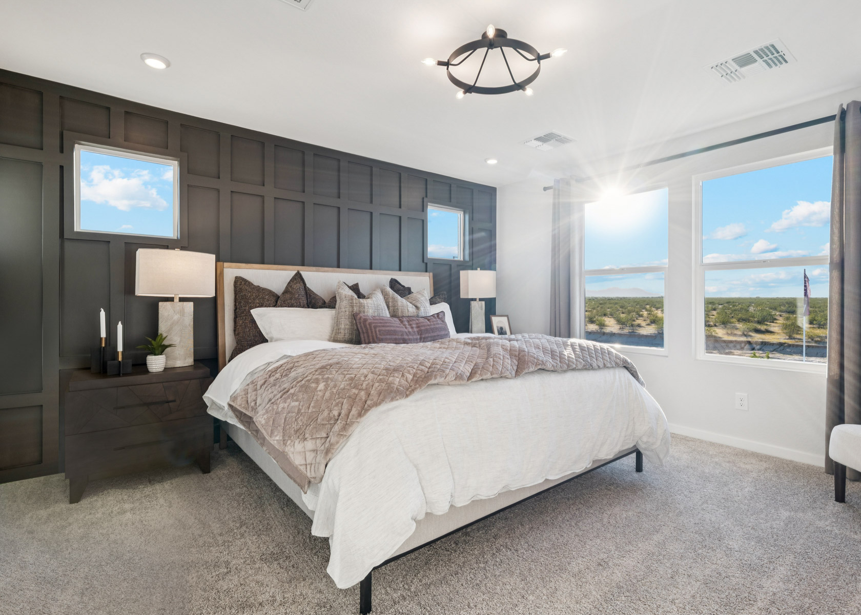 A bedroom with a large window.