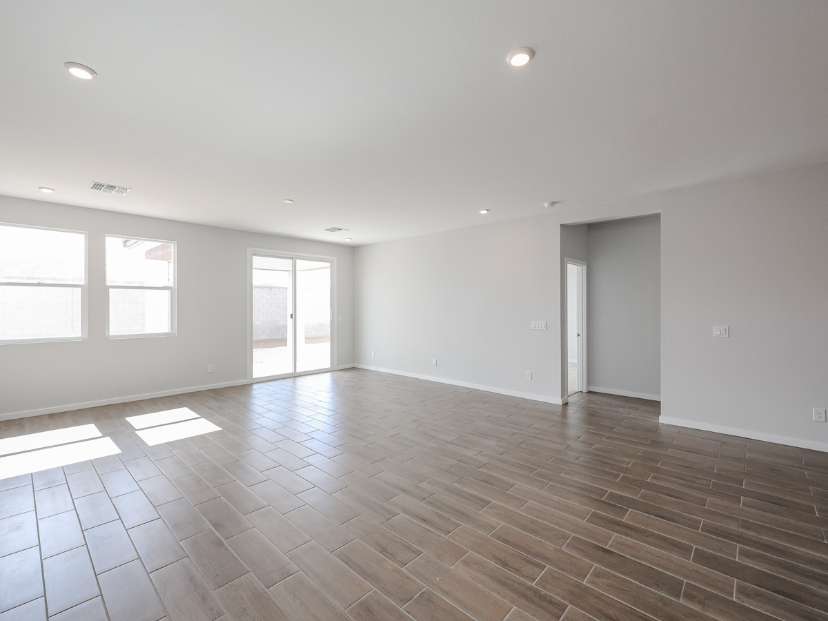 A room with a wood floor and windows.