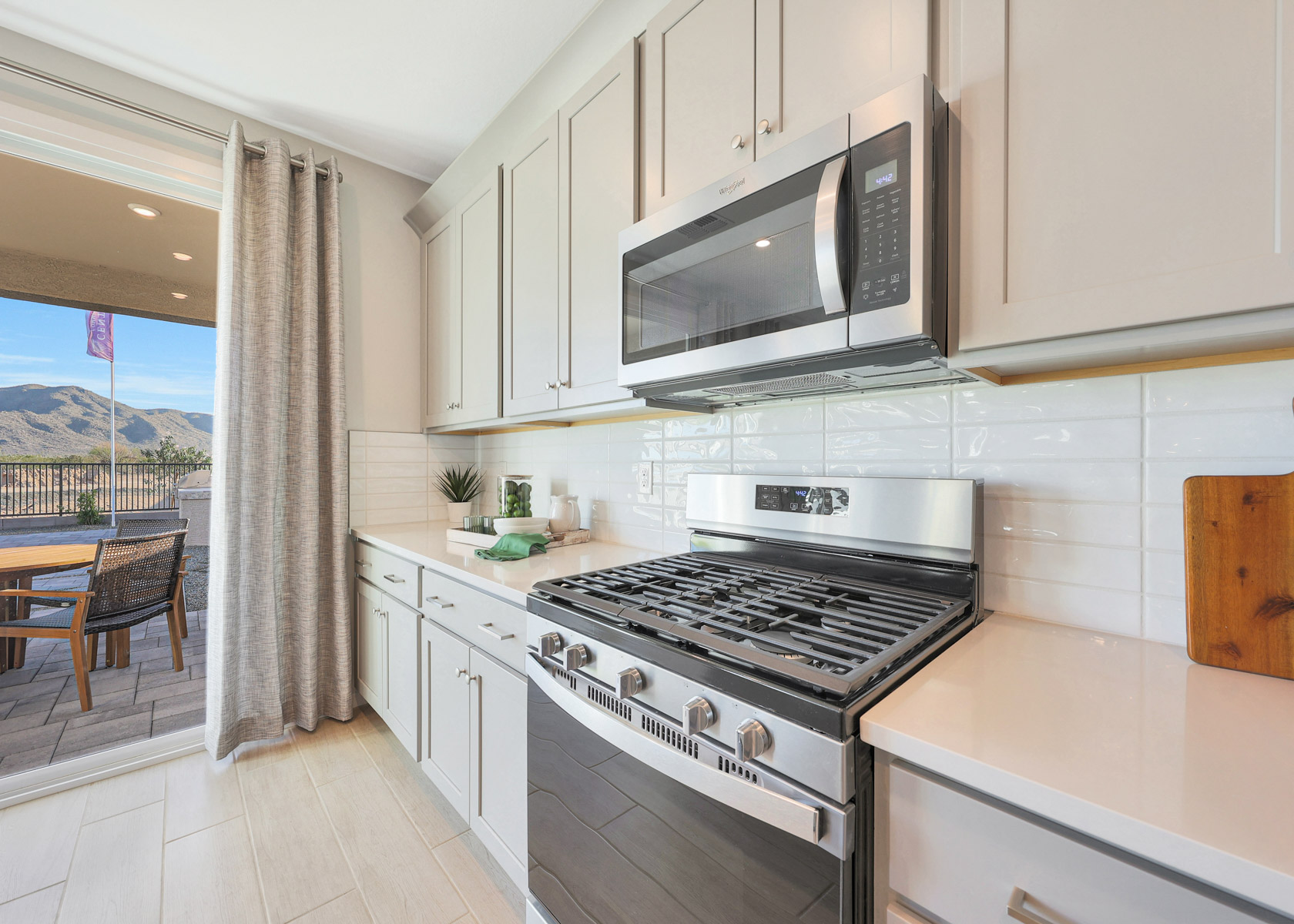 A kitchen with white cabinets.
