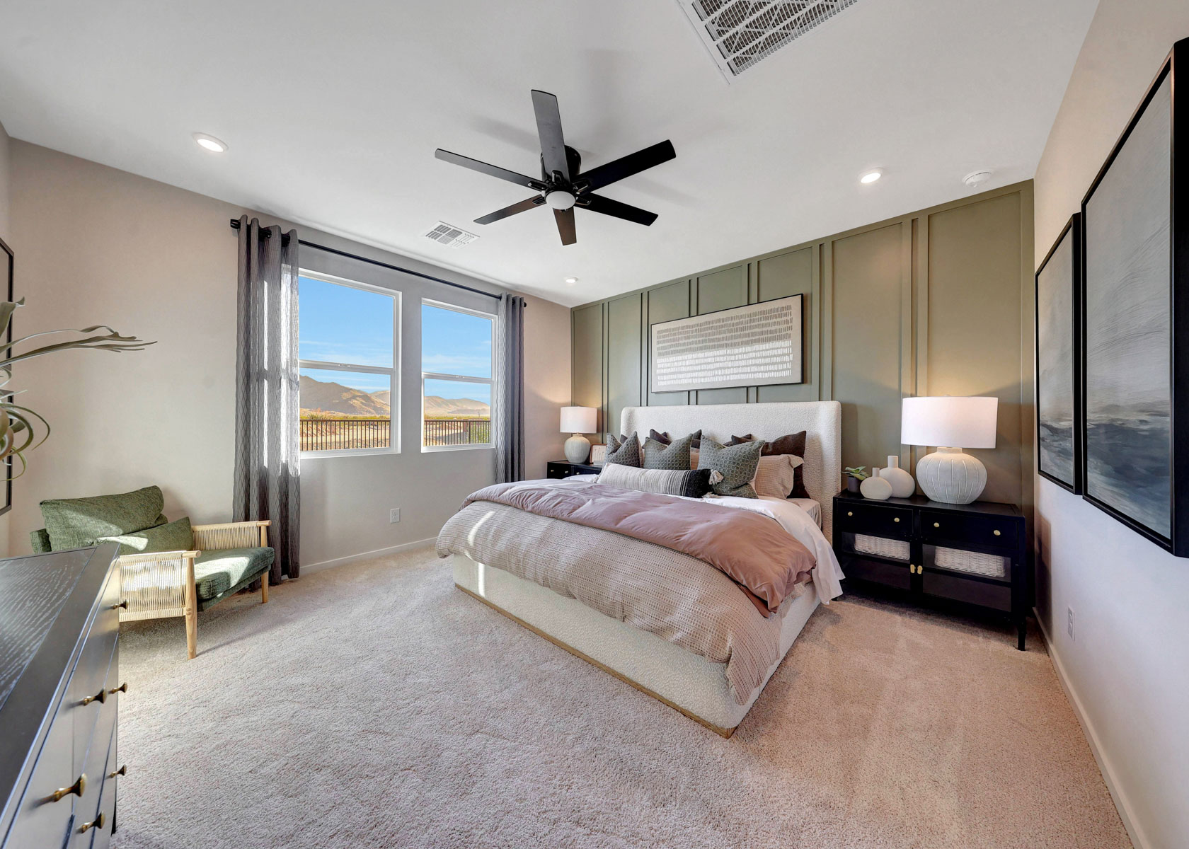 A bedroom with a large bed and a fan.