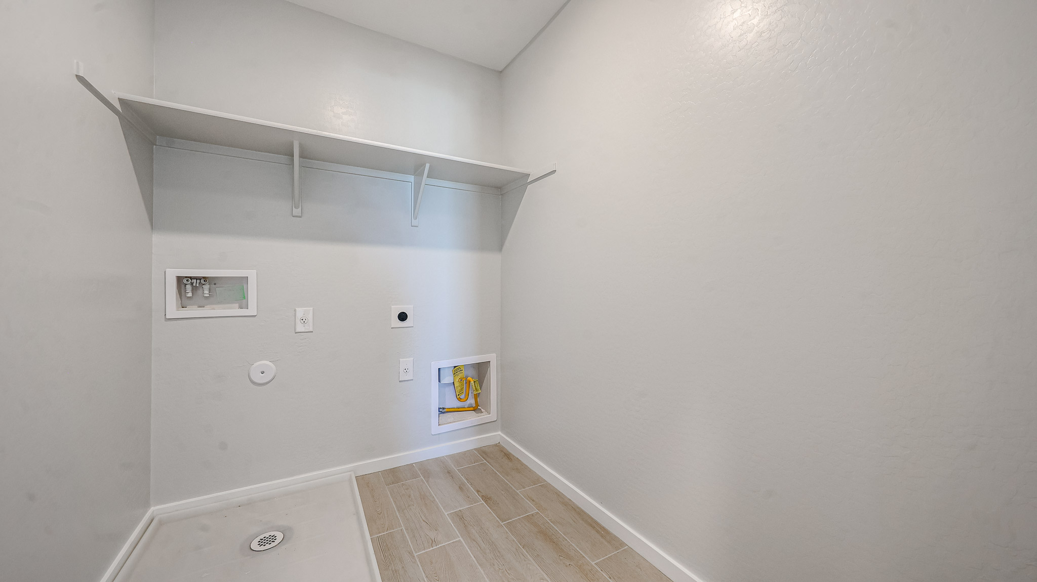 A white room with a tile floor.