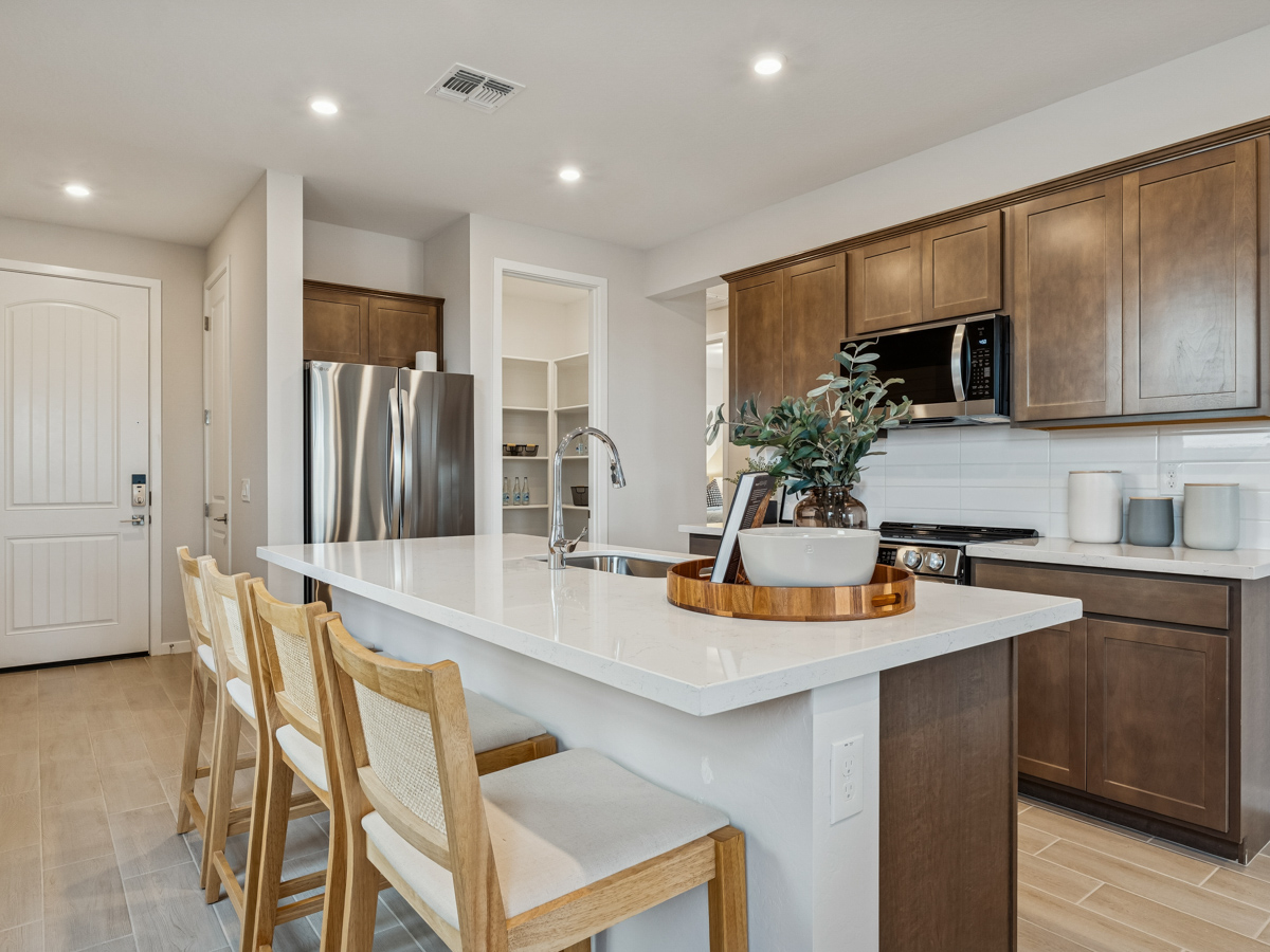 A kitchen with a white counter top.
