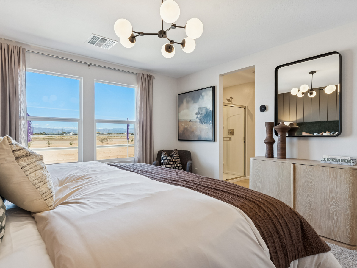 A bedroom with a large window.