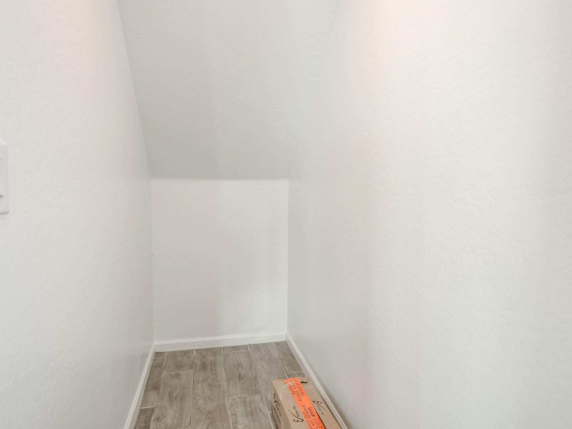 A hallway with white walls.
