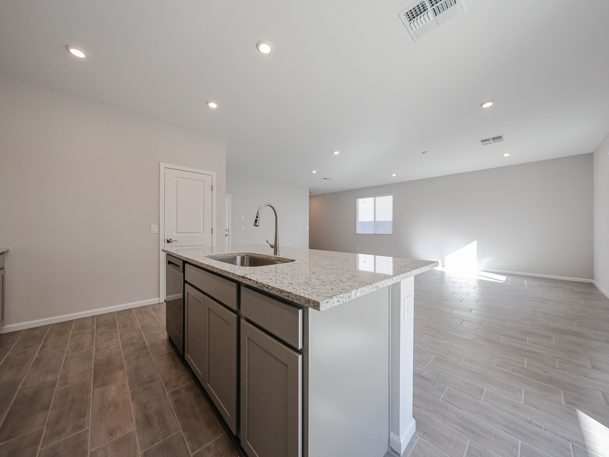 A kitchen with a marble countertop.