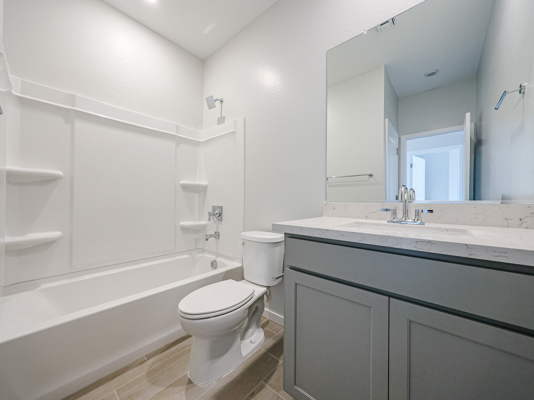 A bathroom with a tub toilet and sink.