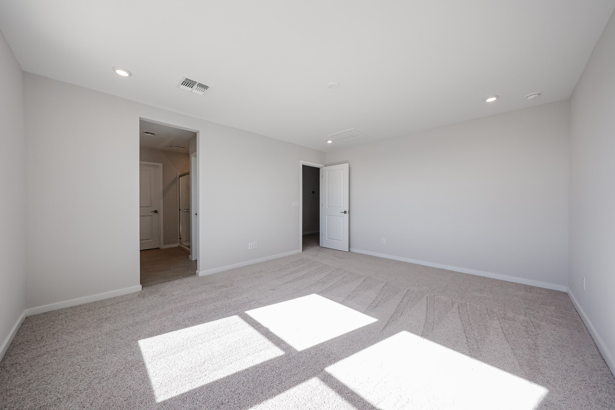 A room with white walls and a rug.