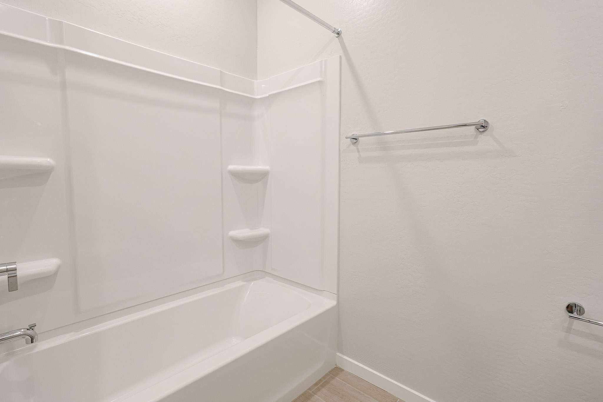 A bathroom with a bathtub and toilet.