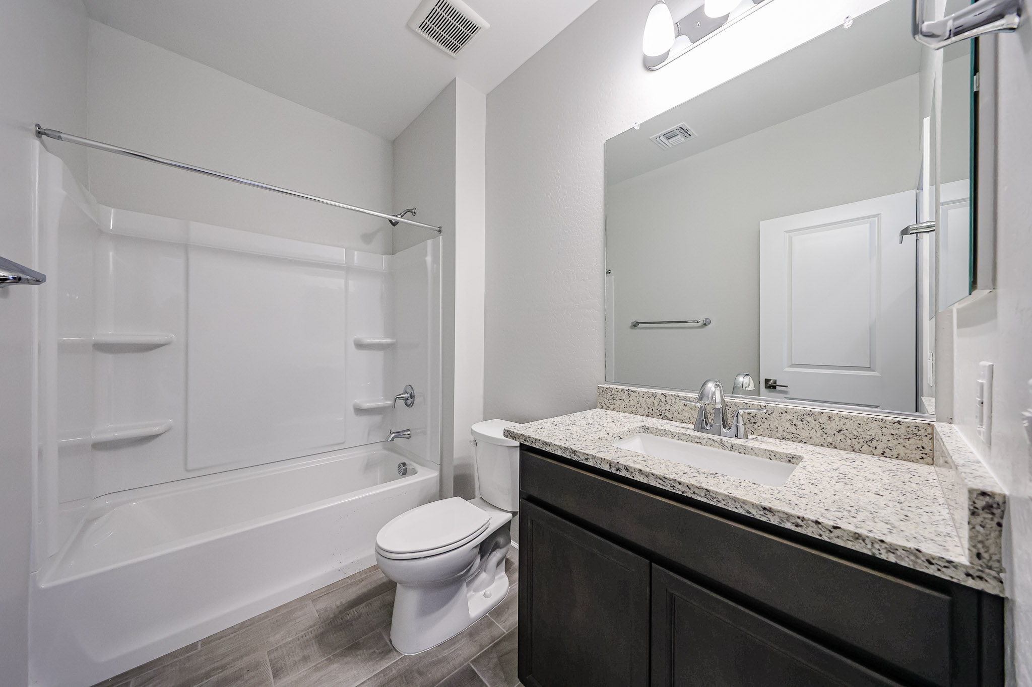A bathroom with a tub sink and toilet.