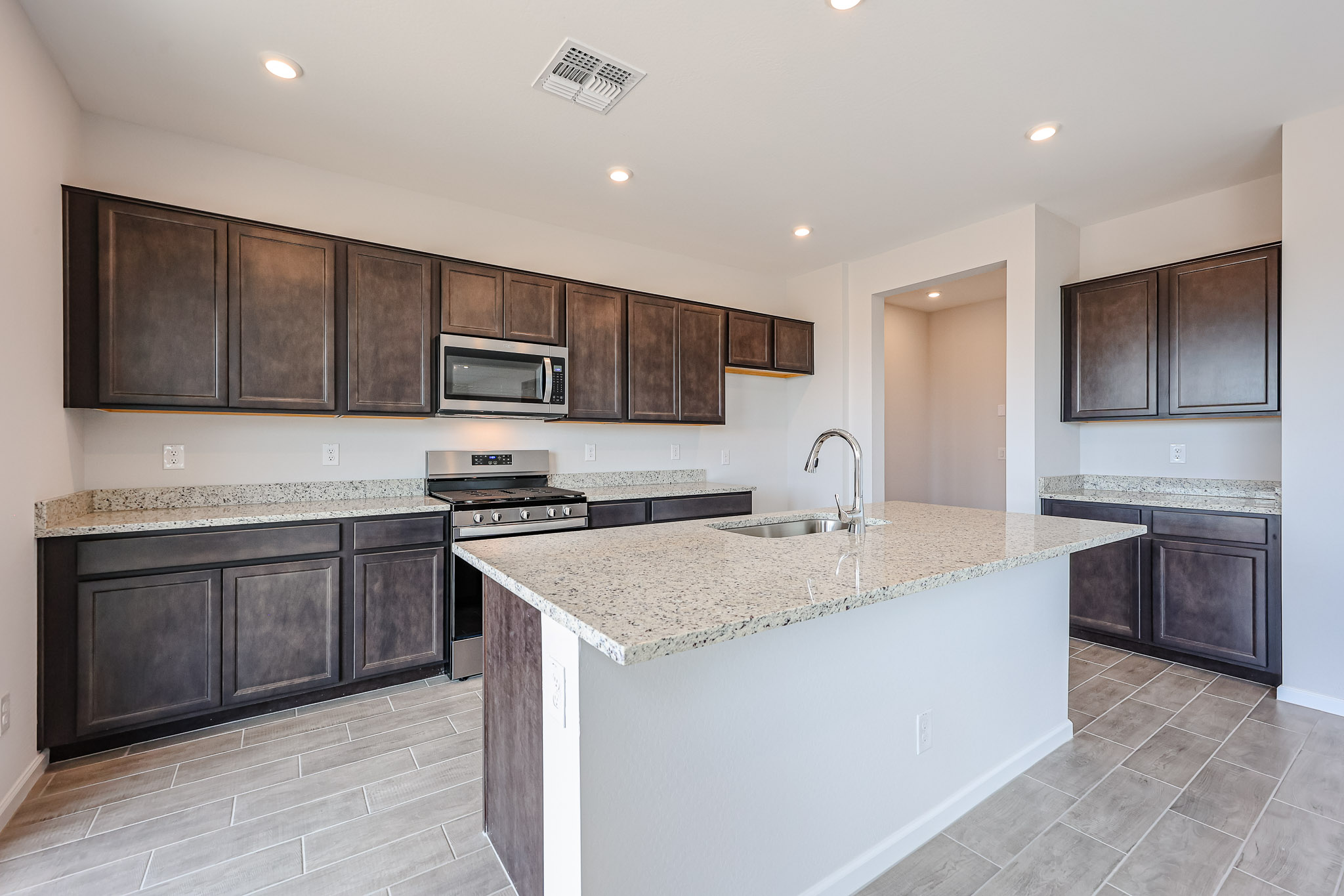 A kitchen with black cabinets.