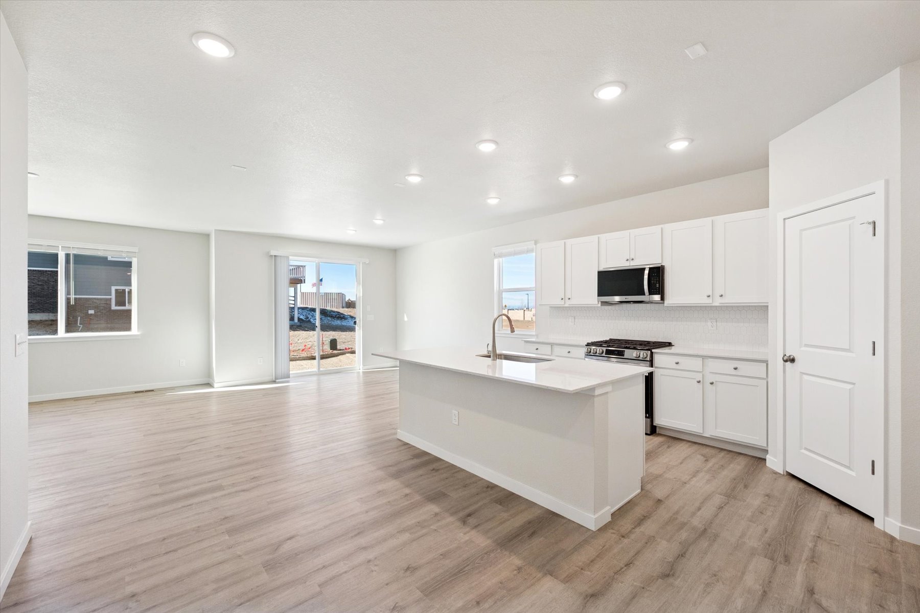 A kitchen with white cabinets.